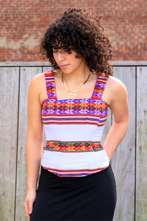 Woman wearing a Latin-inspired,white colorful striped corset top with 2 inch straps, made with Peruvian Aguayo fabric