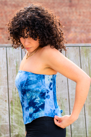 Side profile of a woman wearing a Latin-inspired indigo-dyed strapless corset top, hand-dyed in El Salvador
